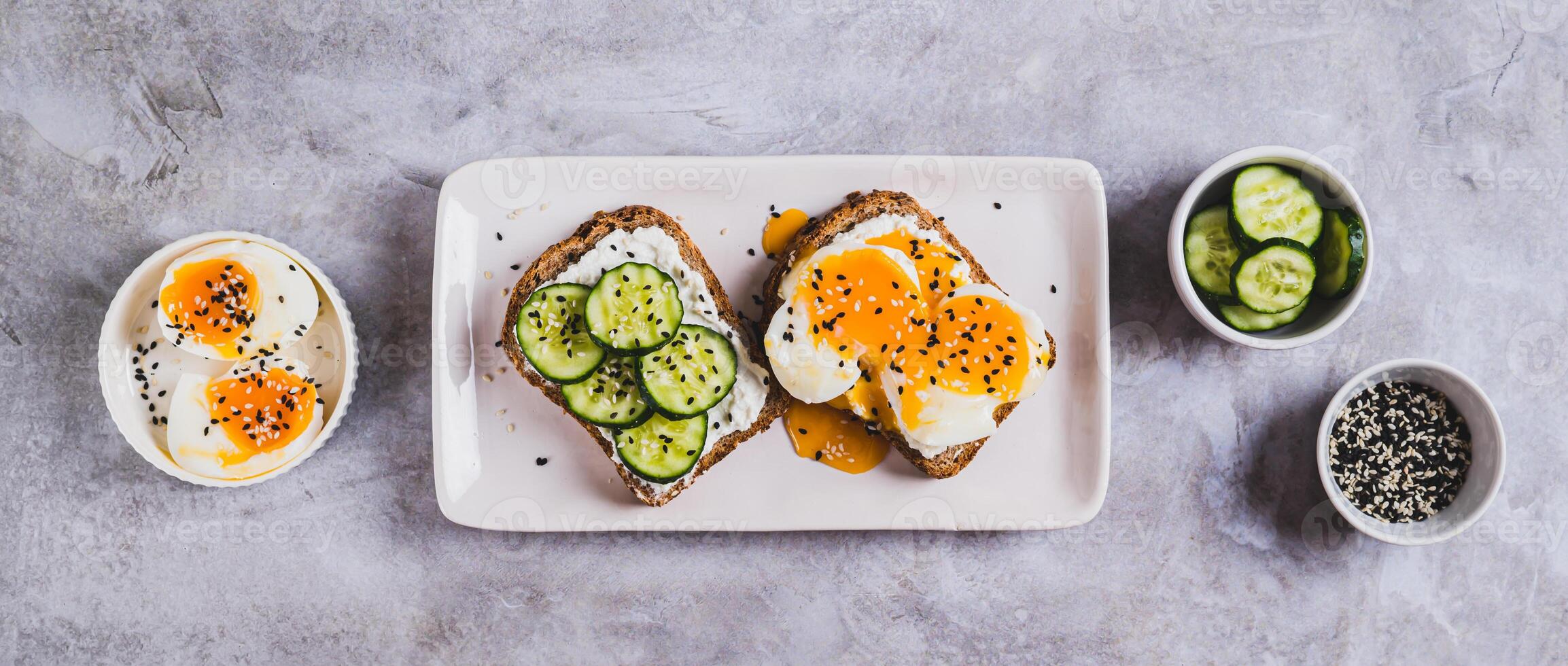 Toast with cucumber and poached eggs photo