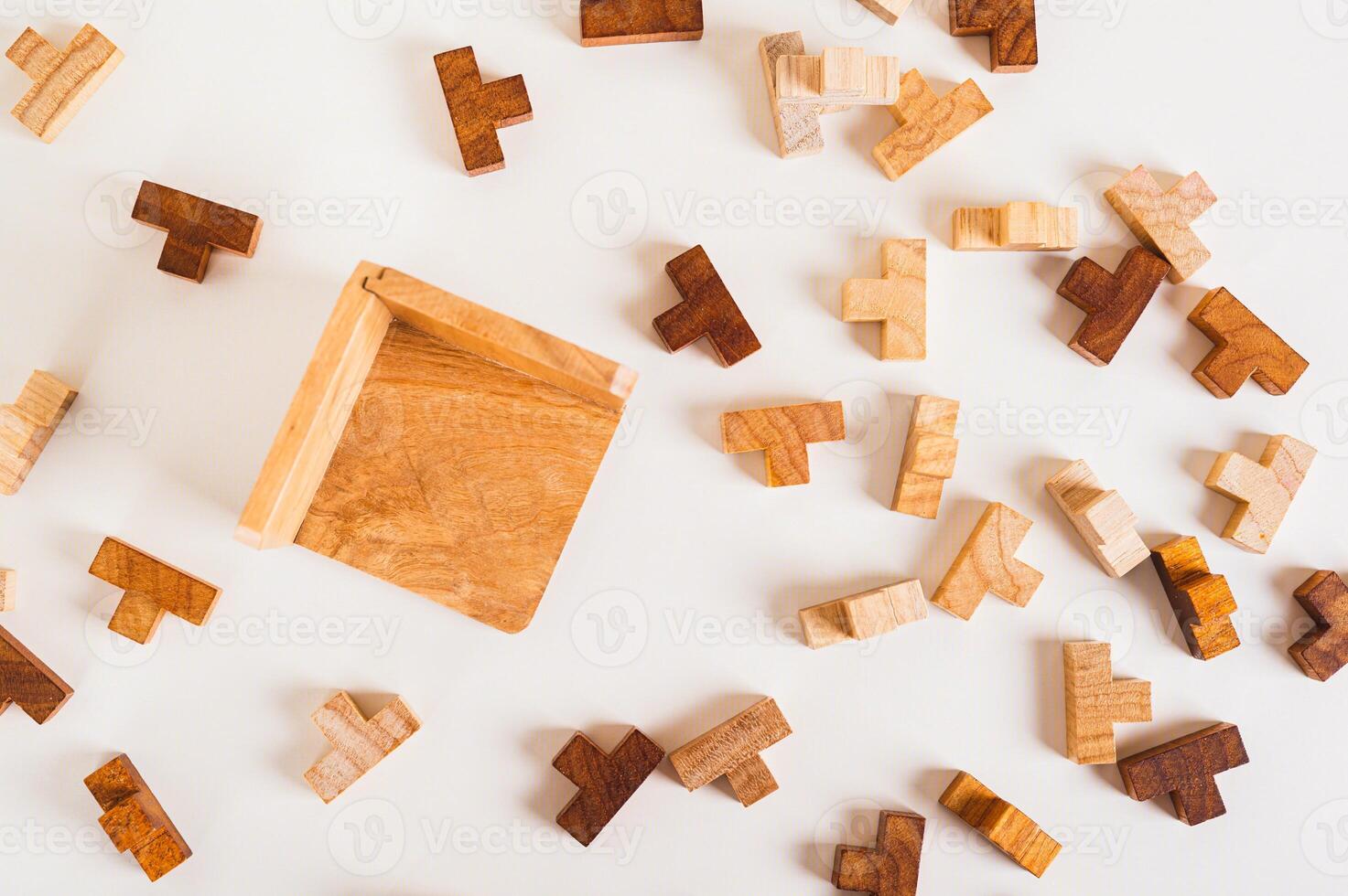 Wooden puzzles and empty collection box on light background top view photo