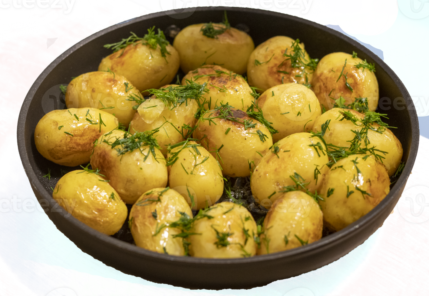 Young jacket potatoes fried in a frying pan and sprinkled with herbs on transparent background png