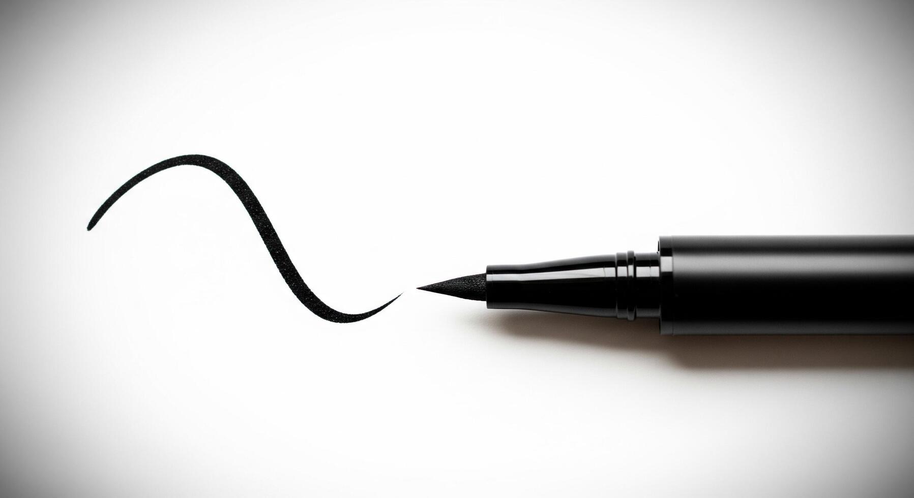 A black pen is writing the word smile photo