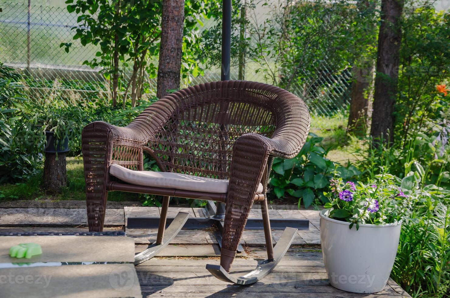 Outdoor rocking chair for relaxation stands in the garden. High quality photo