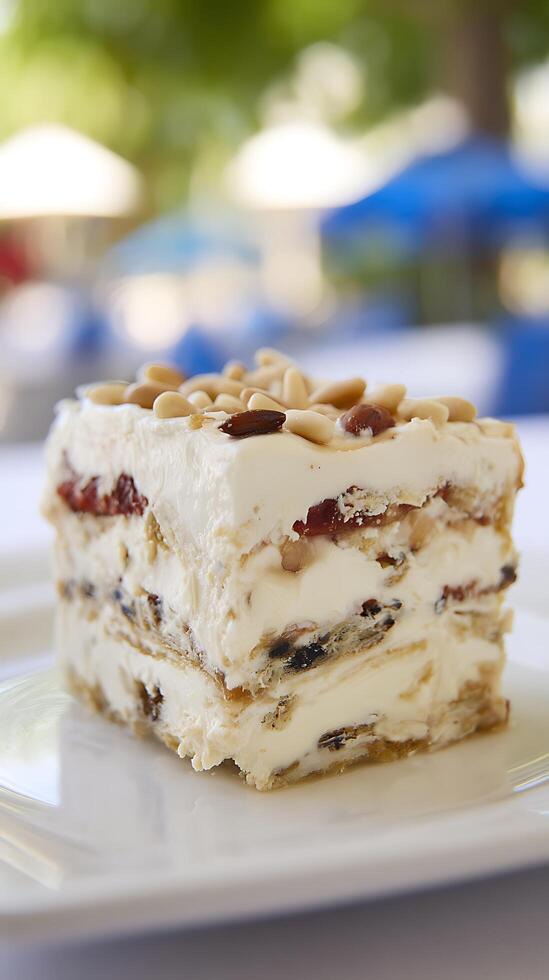 Delicious Dessert Layered Cake With Creamy Frosting And Nuts photo