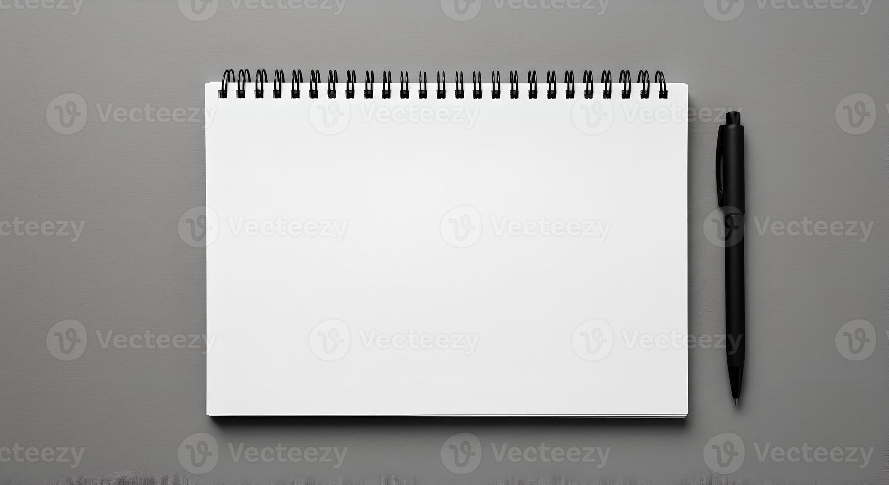 Blank Spiral Notebook with Black Pen on Monochrome Surface Layout. photo