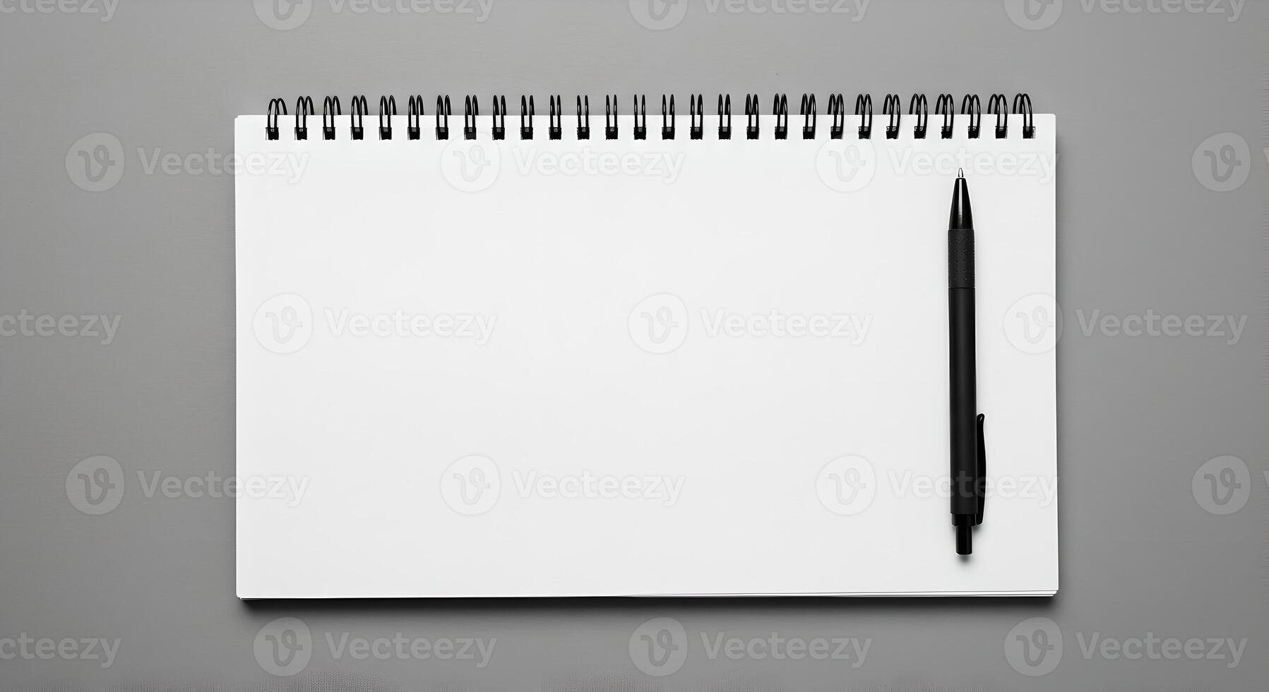 Notebook and black pen on smooth surface with soft lighting, ideal for branding and layout mockups. photo