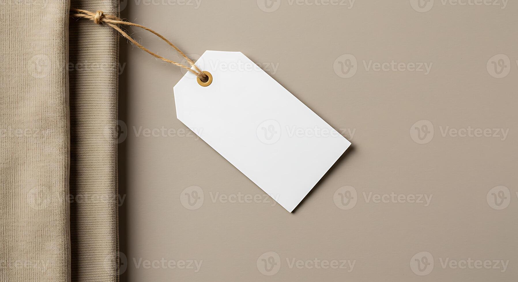Blank White Price Tag Hanging on Neutral Background with Fabric and Rope photo