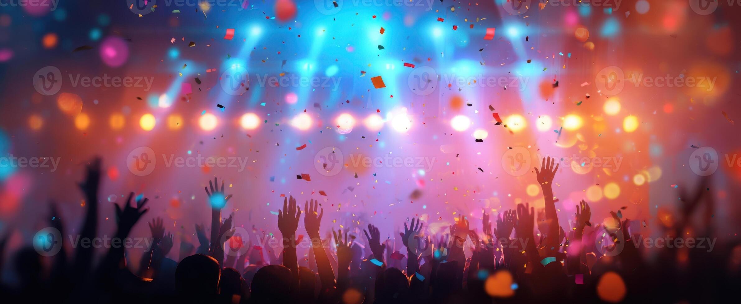 The vibrant celebration of a crowd enjoying a thrilling concert experience. photo