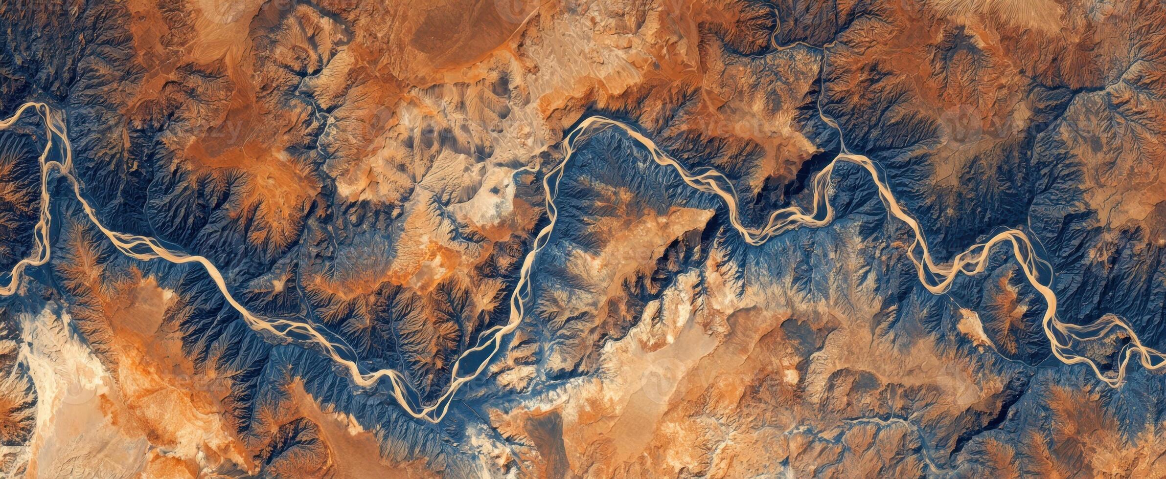 The stunning aerial view of a winding river through rugged mountains. photo