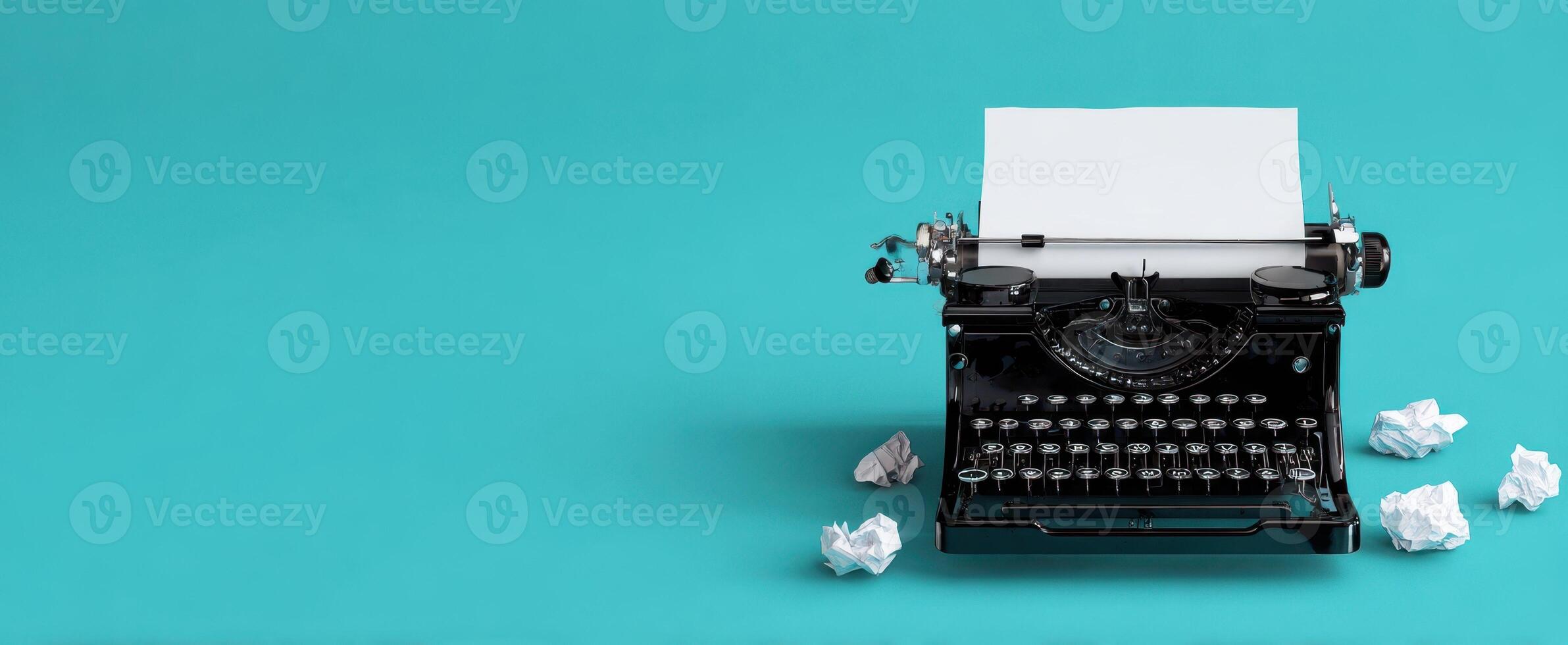 The classic typewriter with blank paper and crumpled drafts on a teal background. photo