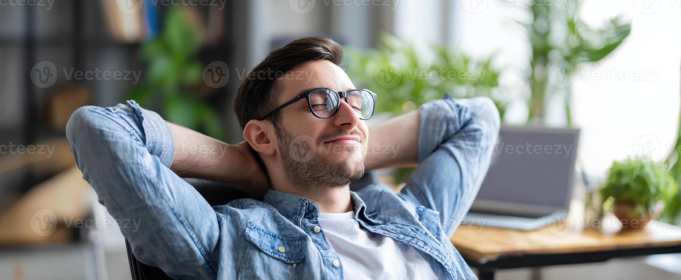The relaxed young man enjoying a moment of tranquility in a modern workspace. photo