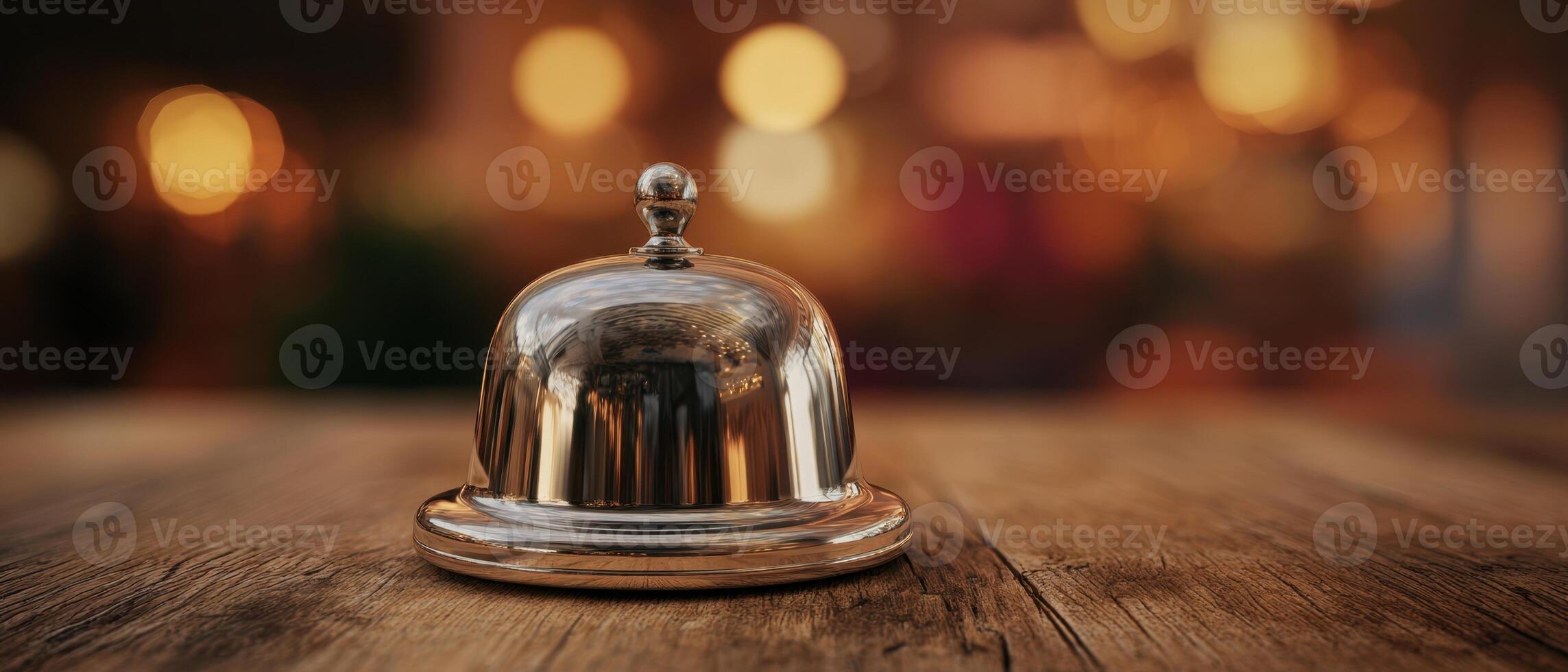 The elegant service bell on a wooden table with bokeh background. photo