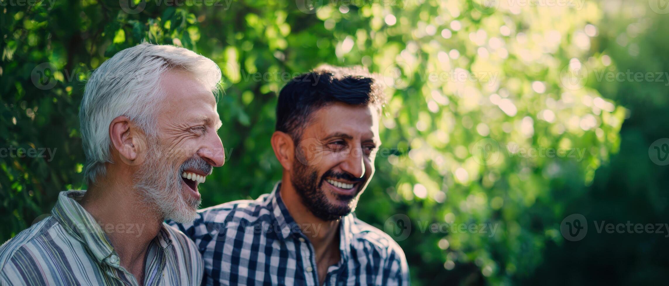 Two men smiling and laughing in the sun photo