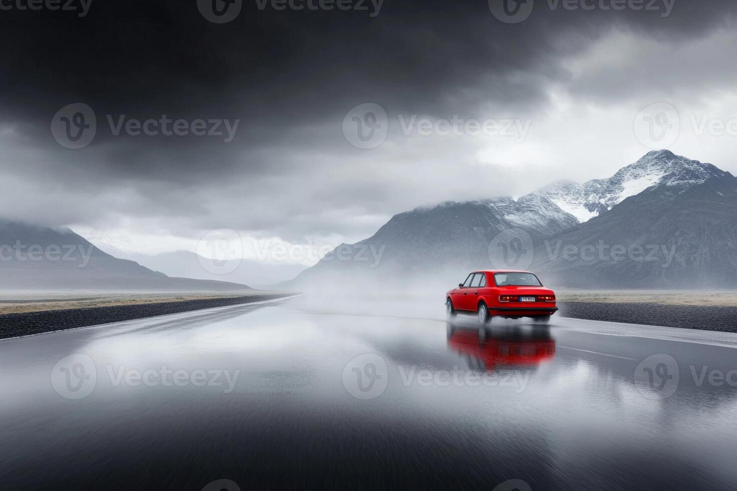 A red car driving on a wet road photo