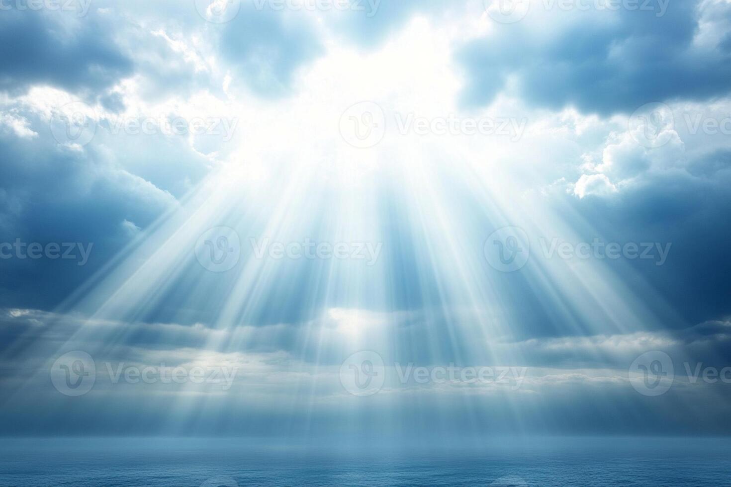 A bright sunbeam shines through the clouds over the ocean photo