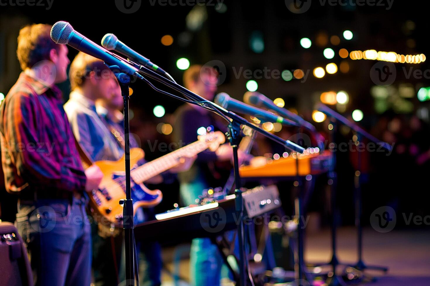 A group of people playing music on stage photo