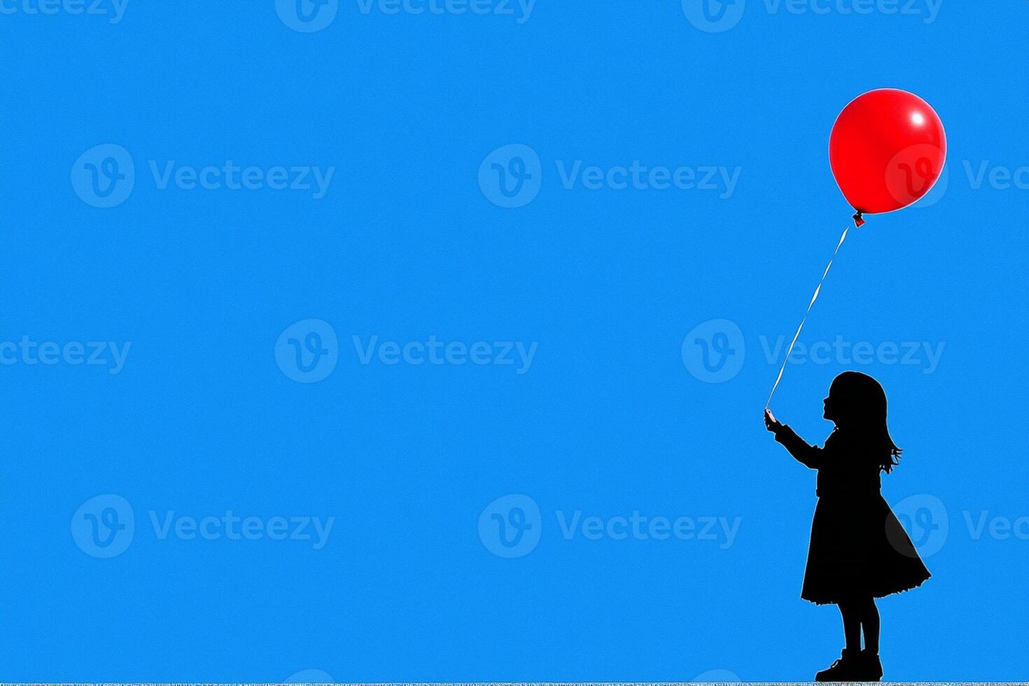 A girl holding a red balloon in the air photo
