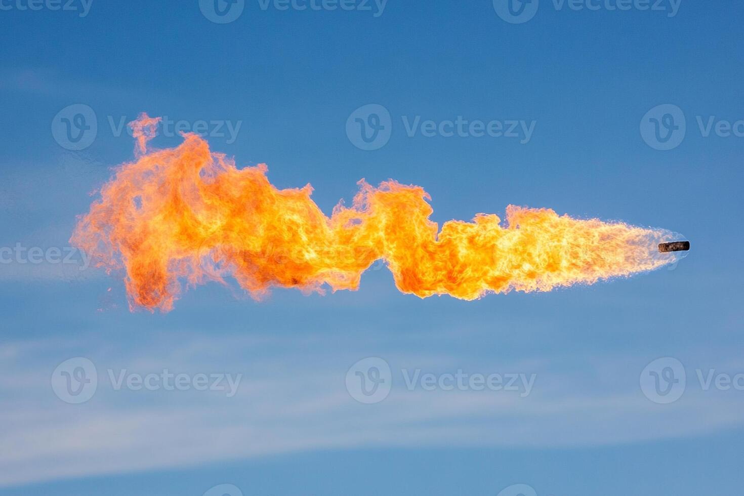 A large orange flame is being blown out of a jet photo