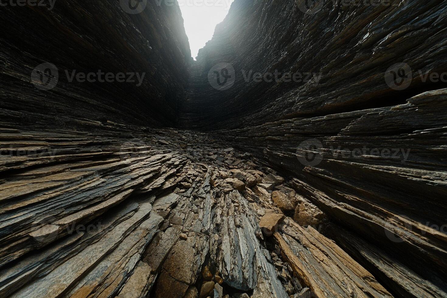 A narrow tunnel in the middle of a rocky mountain photo
