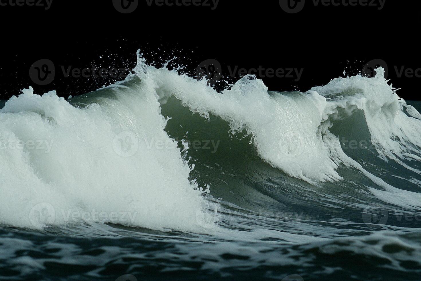 A person riding a wave on a black background photo
