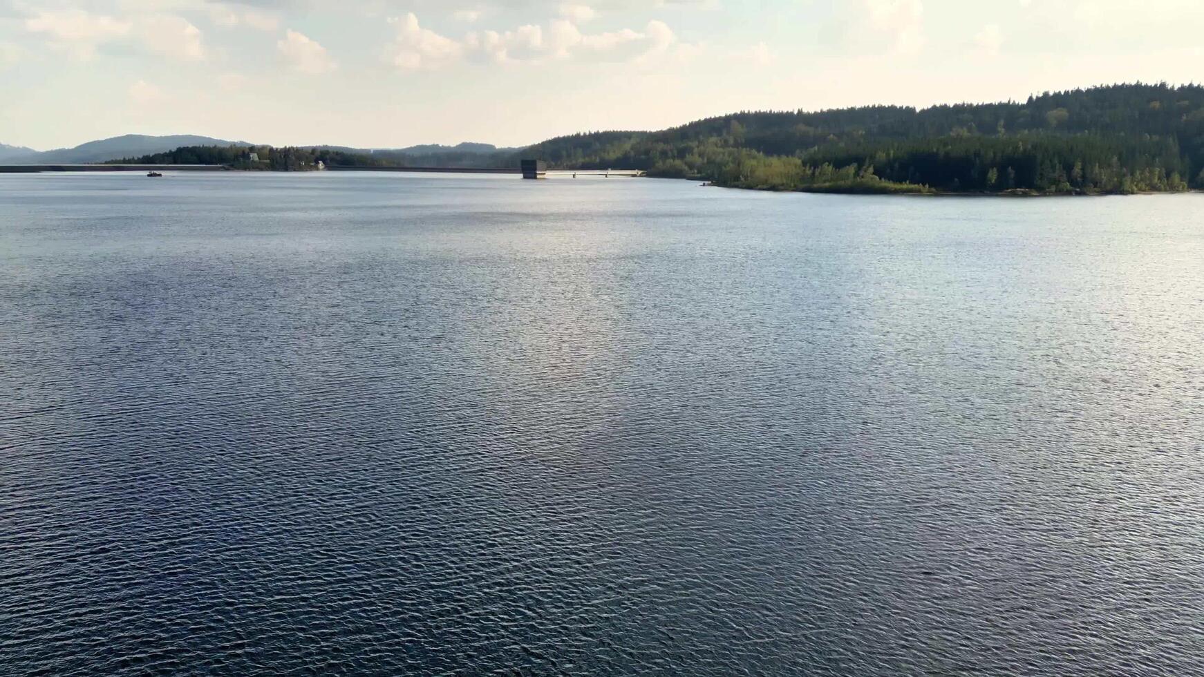 The Serene Waters of a Tranquil Lake are beautifully accompanied by Lush Surroundings all around photo