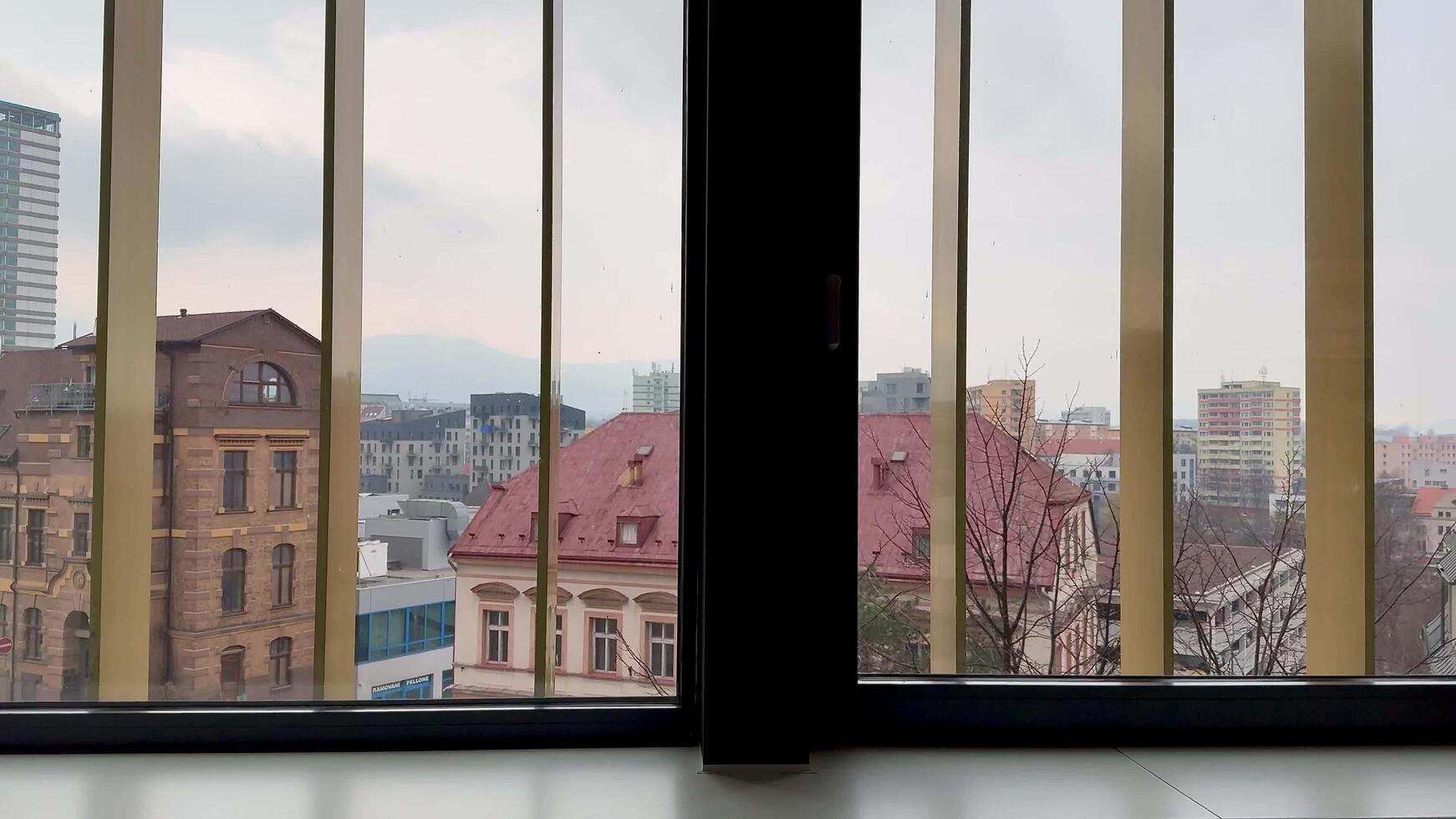A stunning cityscape view observable through the intricate bars of a window frame photo