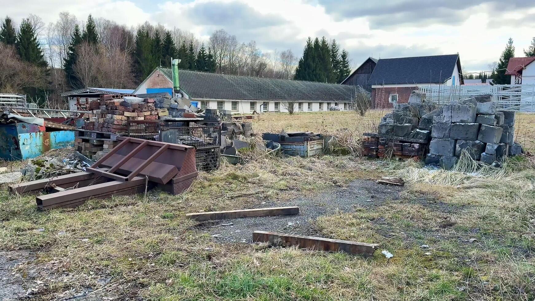 An Abandoned Industrial Site Filled with Rusty Materials and Overgrown Tall Grass Over Time photo