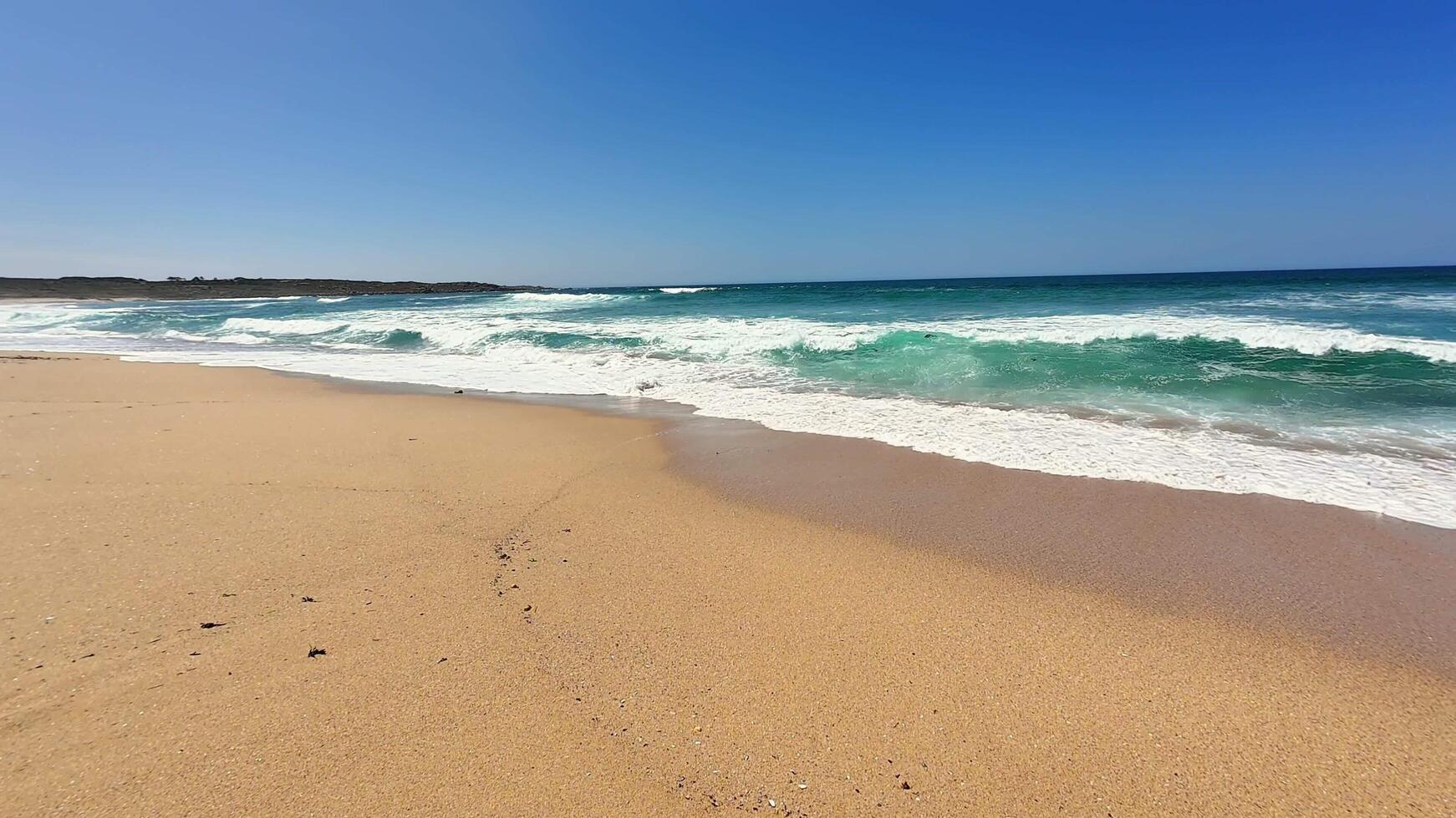A Serene Coastal View featuring Gentle Waves and a Beautiful Sandy Shoreline to Enjoy photo