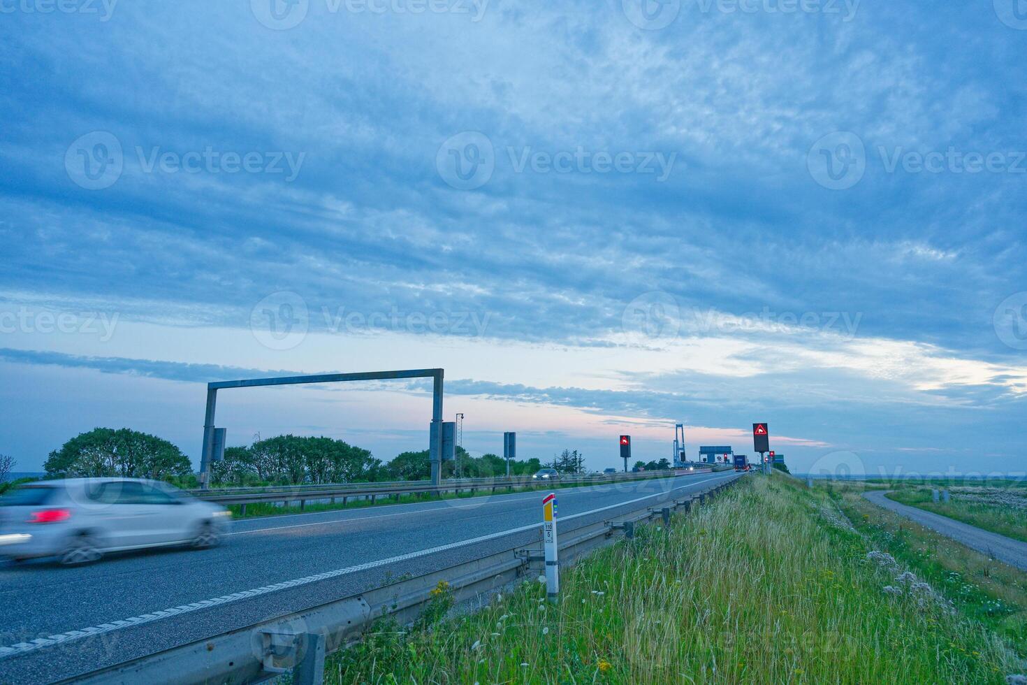 Danish Oresund OEresund Bridge viewed from the east side near Korsor in Denmark at dusk with signs photo