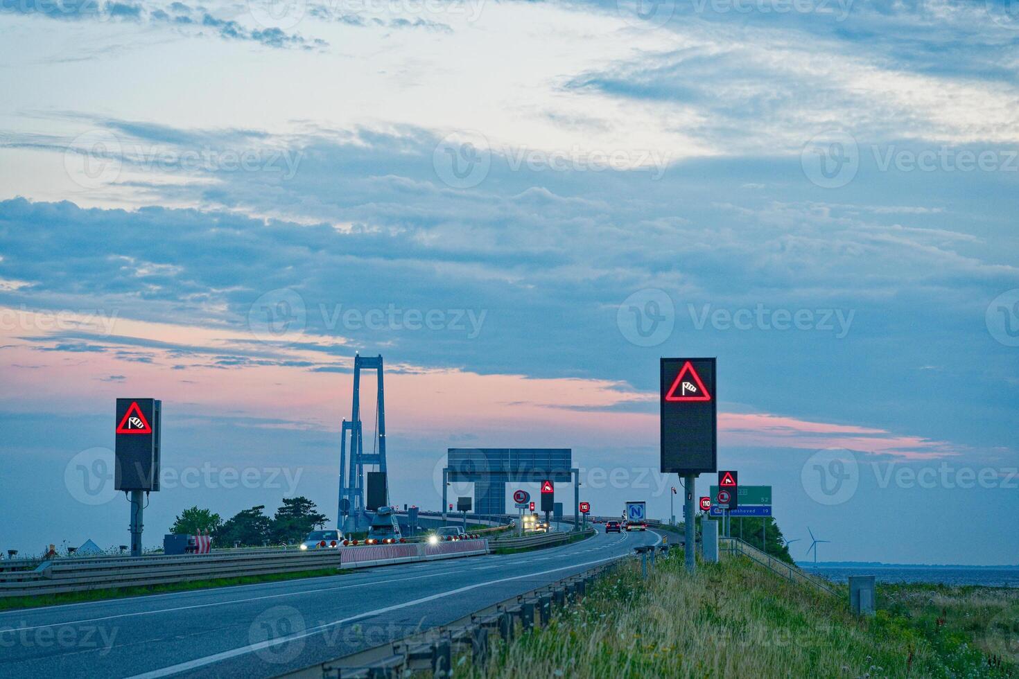 Iconic Oresund OEresund Bridge viewed from the east side near Korsor in Denmark at dusk with many signs photo