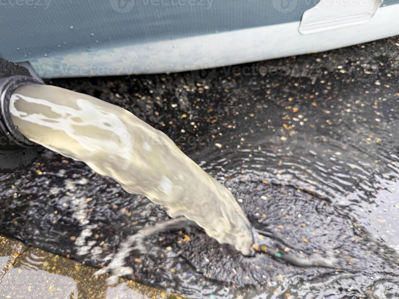 Backwashing pool water through the sand filter system shows dirty water to clean the filter sand photo