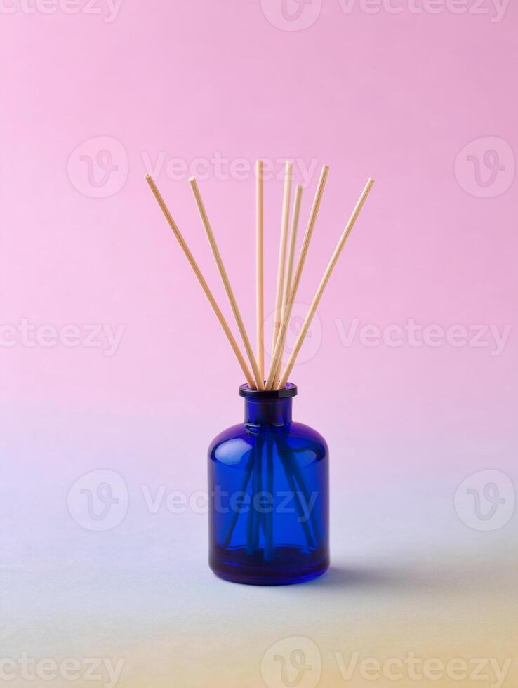 Blue Diffuser with Reeds on Color Gradient Background photo