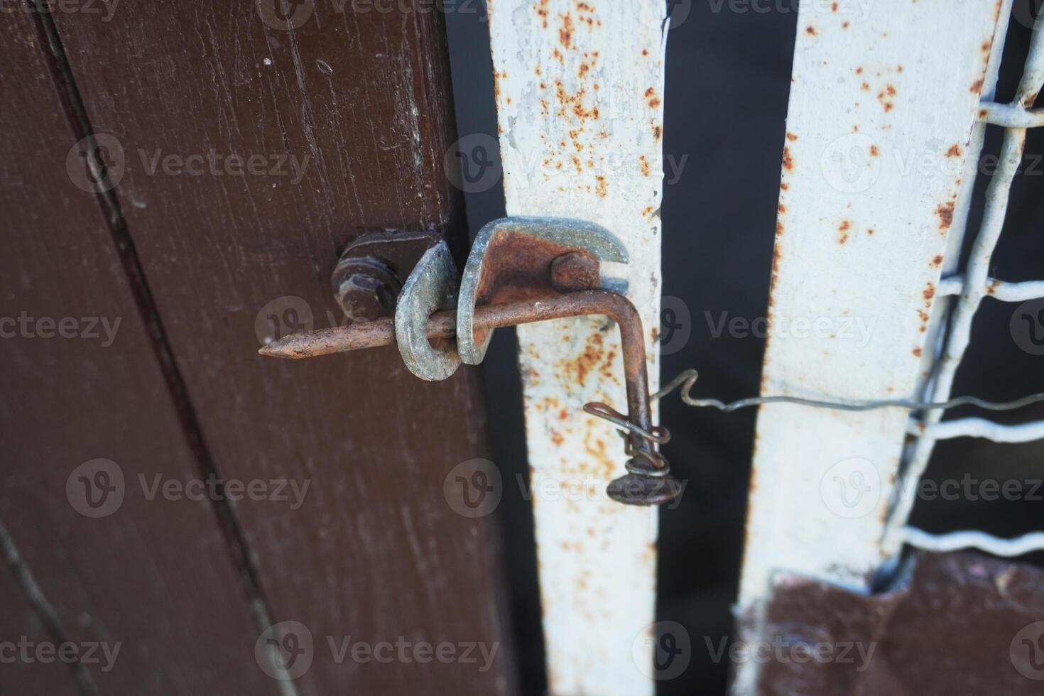 An old nail and wire lock. At first glance, it looks flimsy, but it's a time-tested thing that allows you to protect yourself from unauthorized entry. photo