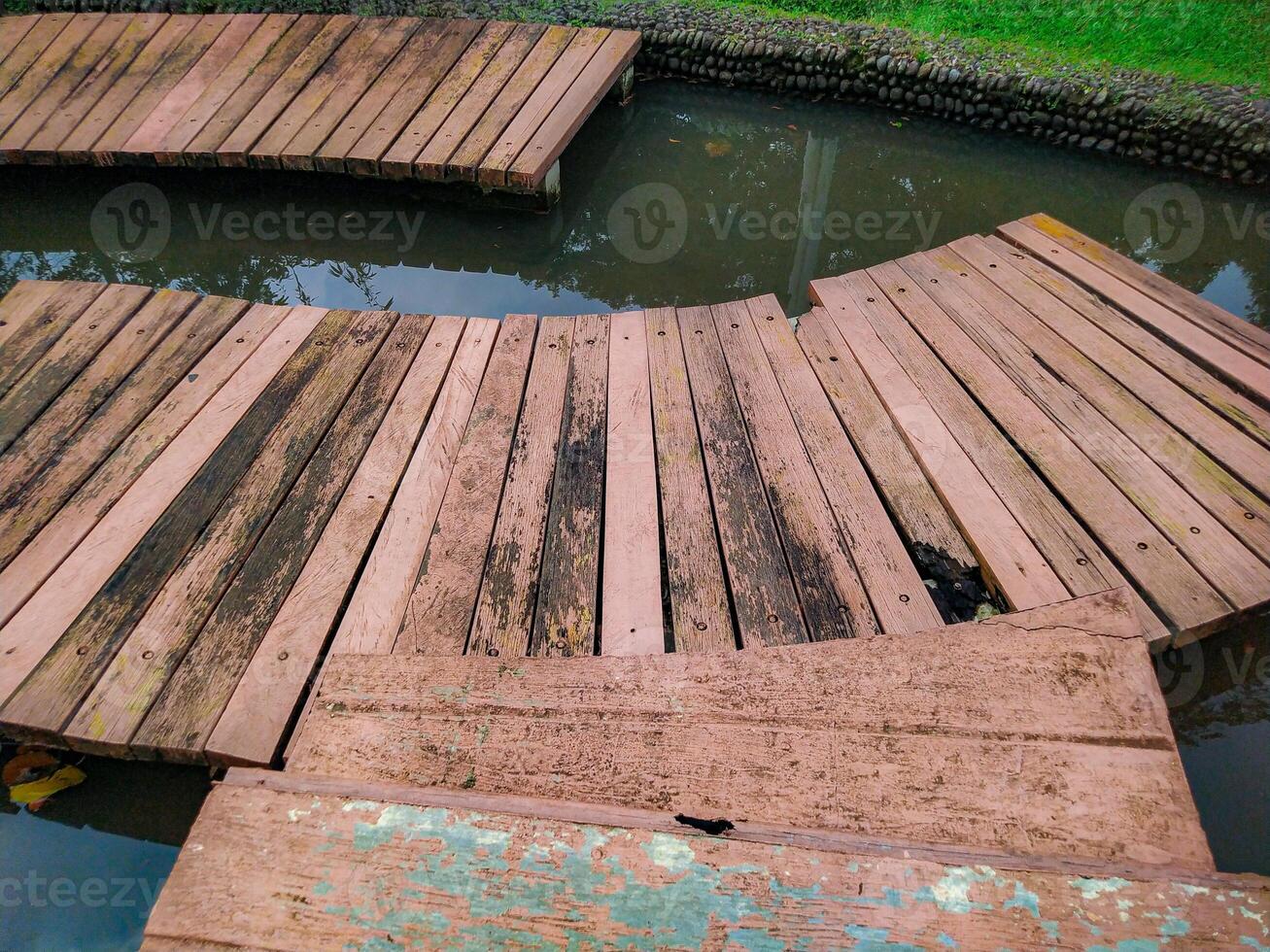 Walking on Wooden Path Over Water in a Garden or Park photo