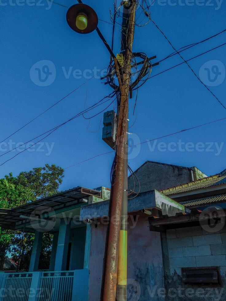 Rusty Utility Pole with Streetlight A Vivid Urban Scene photo