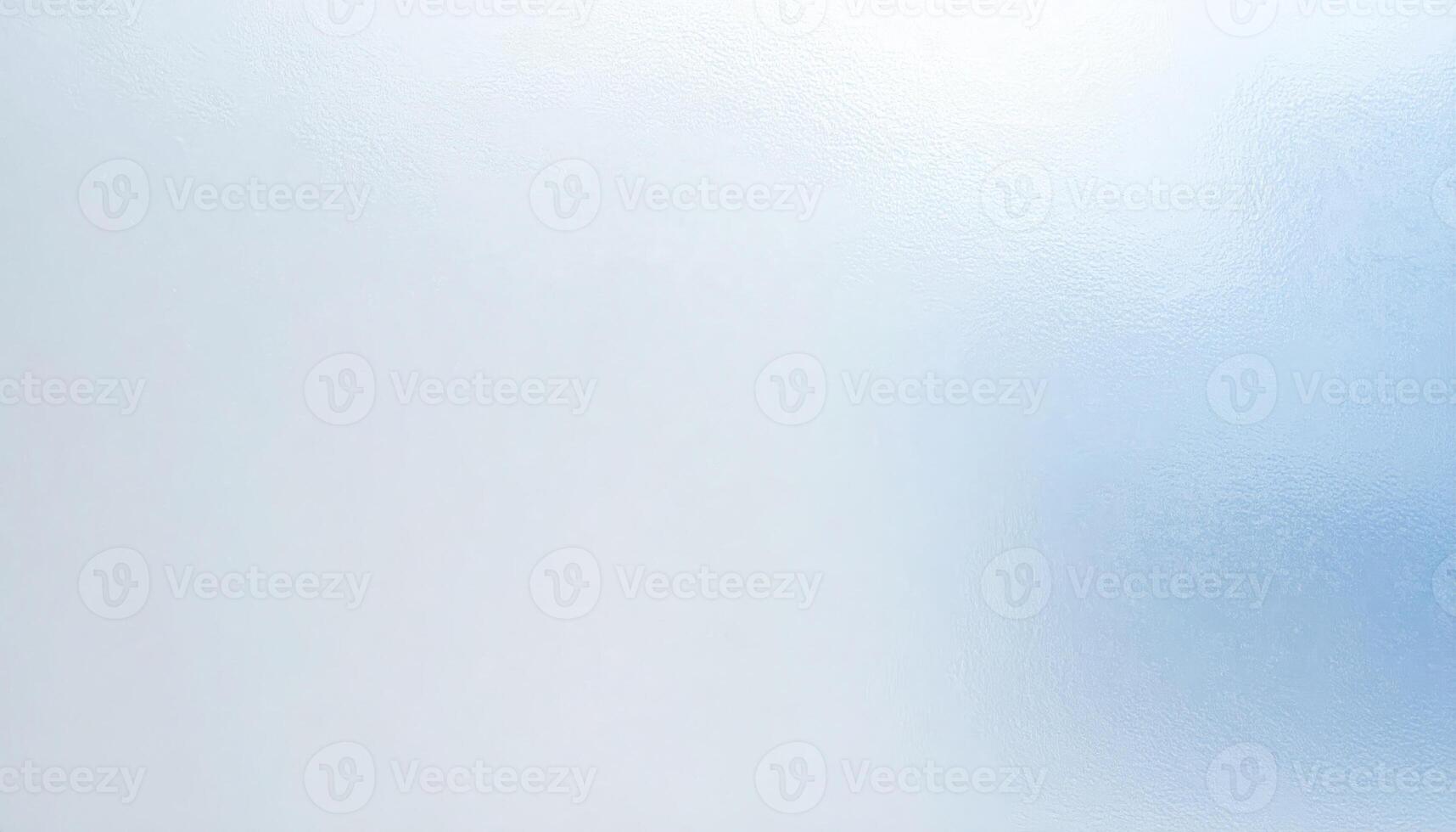 Close-up of hazy, frosted matte glass with a blurred backdrop photo