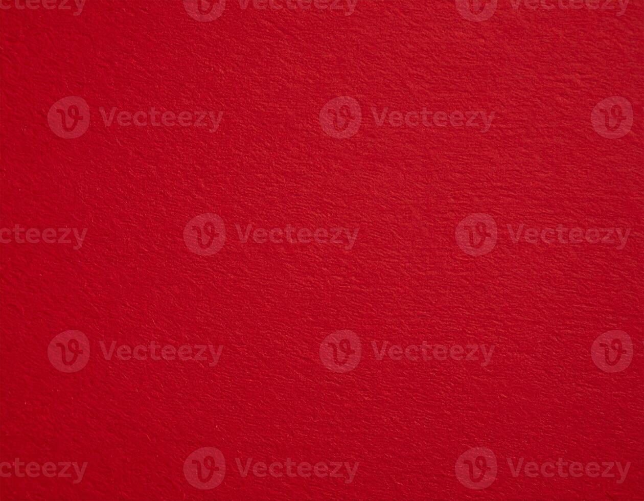 Close-up of deep red textured paper background, ideal for presentation themes photo