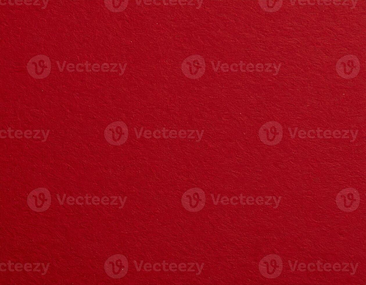 Close-up of a deep crimson paper surface with a textured background, ideal for presentation designs photo