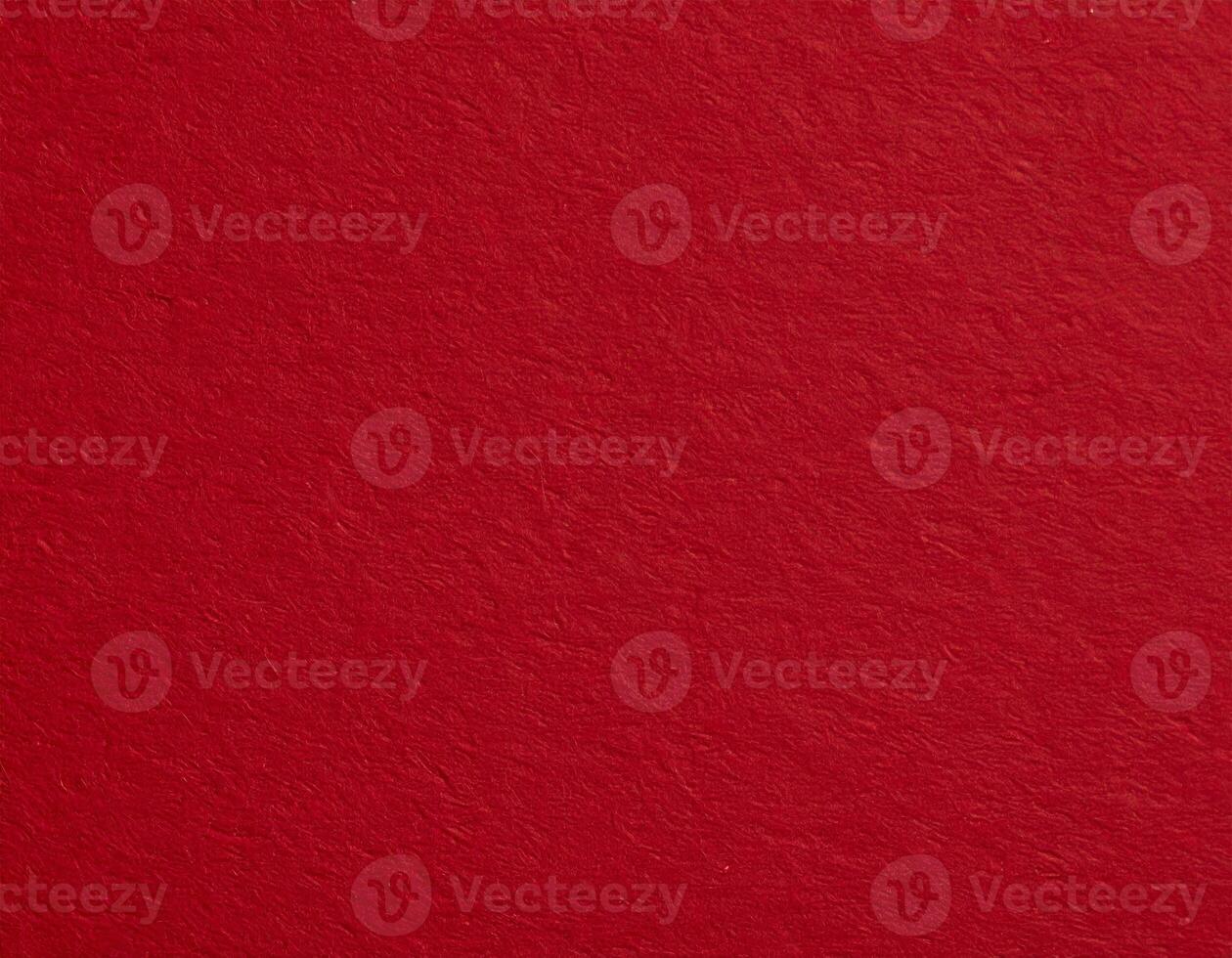 Close-up of deep crimson paper surface with a textured pattern, suitable for presentation backgrounds photo