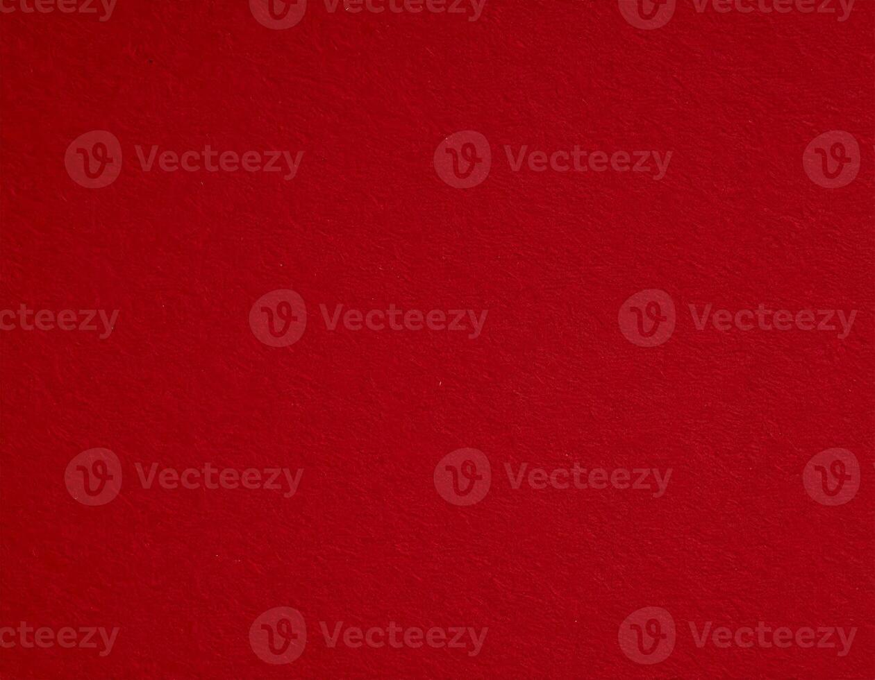 Close-up of deep crimson paper surface with textured red pattern, suitable for presentations. photo