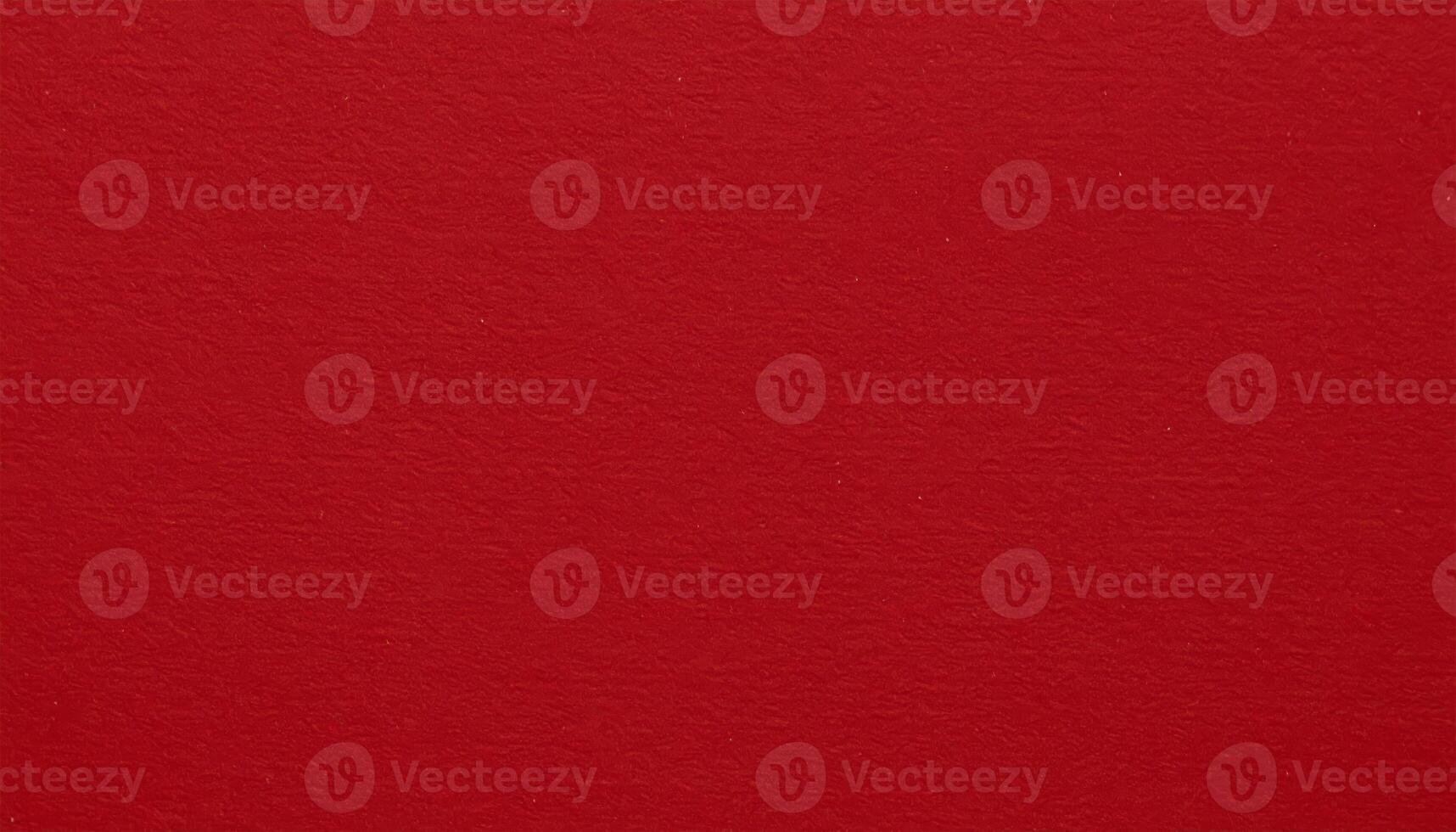 Close-up of a deep red paper surface with a textured pattern, ideal for presentation backgrounds photo