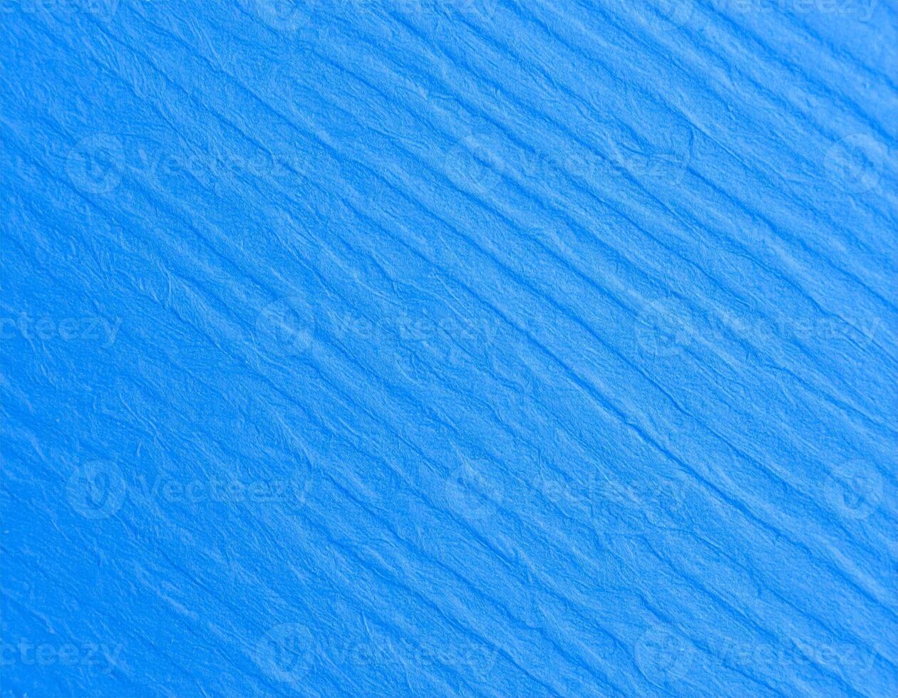 Close-up of a vibrant blue paper with an electric texture and pattern as the background photo