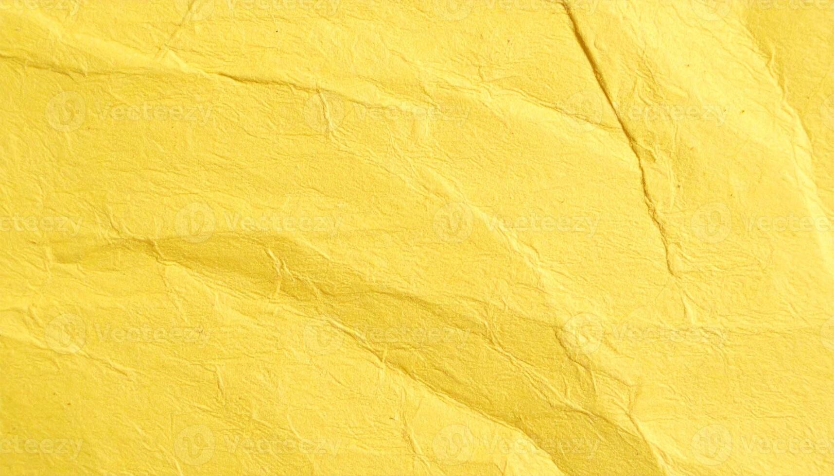 Close-up of a yellow, coarse-textured paper surface with a natural pattern photo