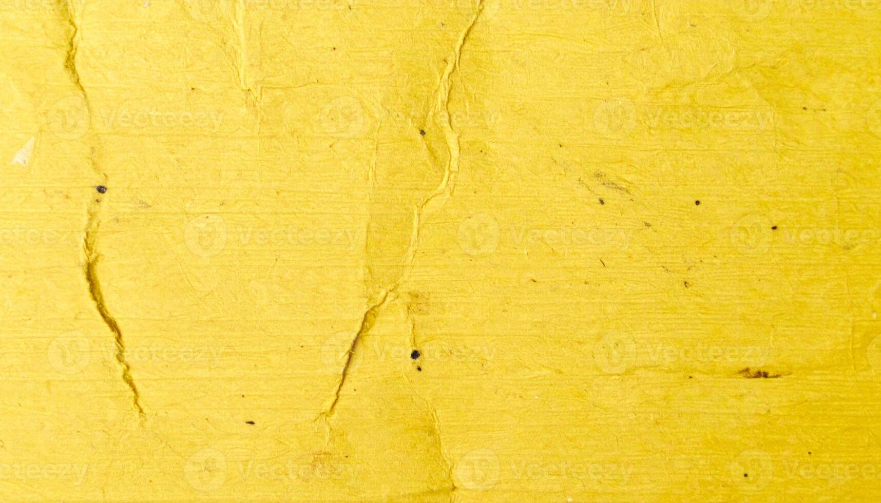 Close-up of a yellow, textured, rough paper surface pattern photo