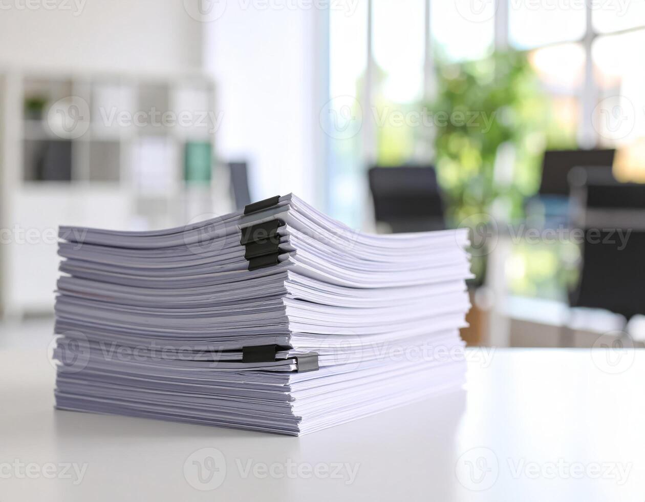 Office desk cluttered with stacks of reports and documents against a background of paperwork photo
