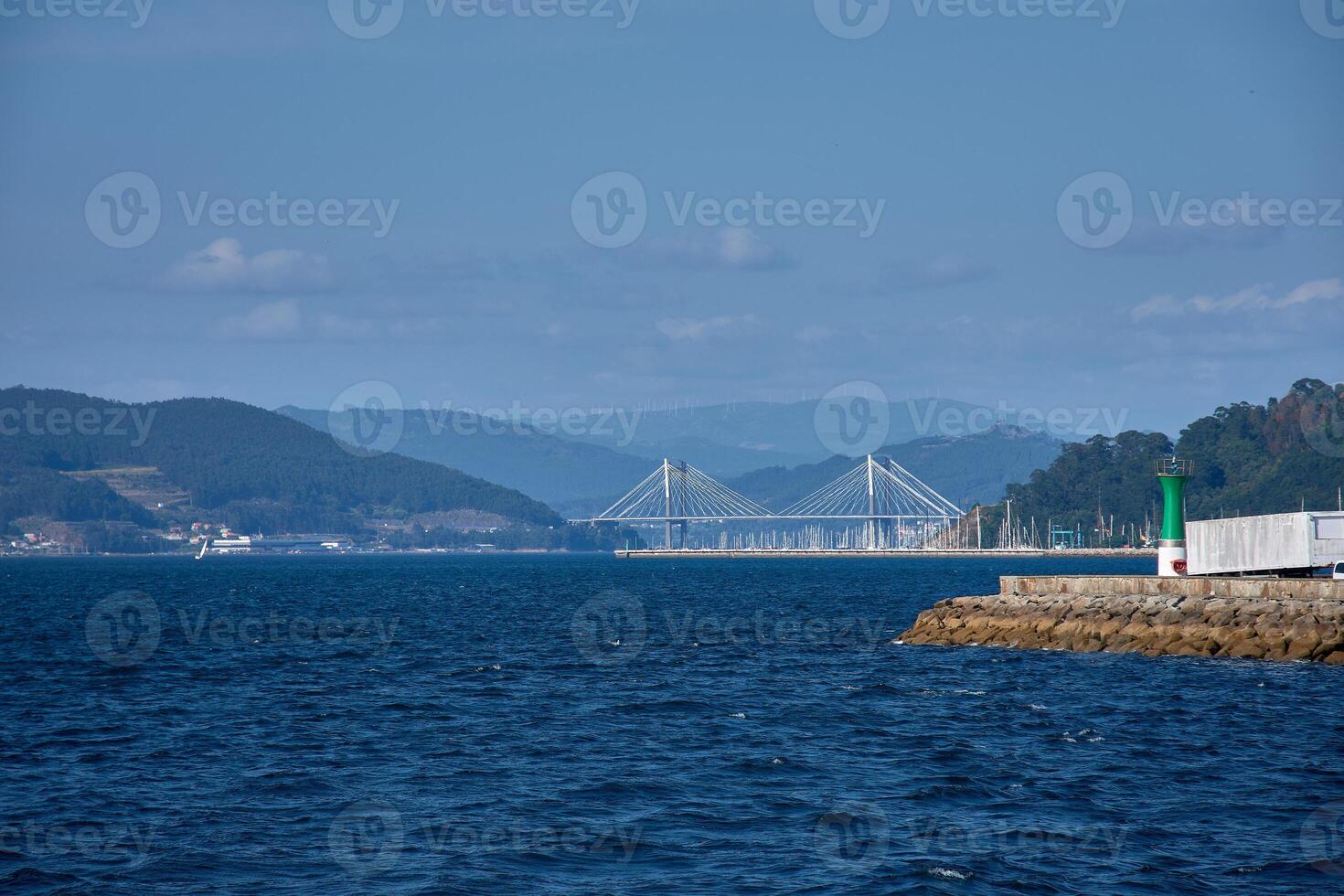 Rande Bridge seen from a boat sailing through the Vigo Estuary, with a mountain landscape and the intense blue of the Galician Atlantic. photo