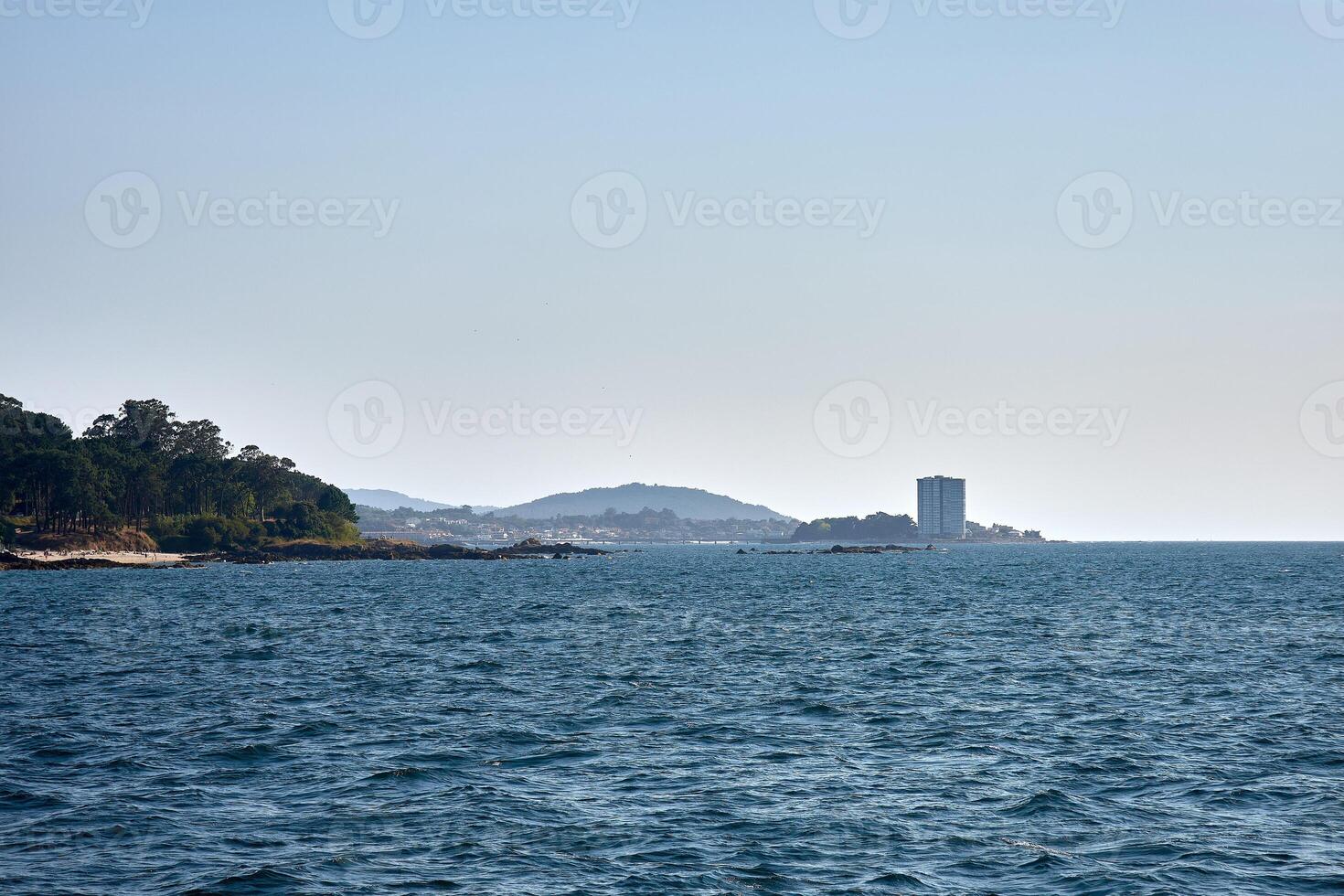 Panoramic view from the sea toward Toralla Island in Vigo, Galicia, with the Atlantic Ocean and a clear summer sky photo