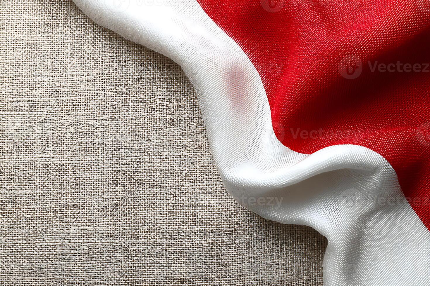 Red White Fabric Flag Draped on Natural Linen Background photo