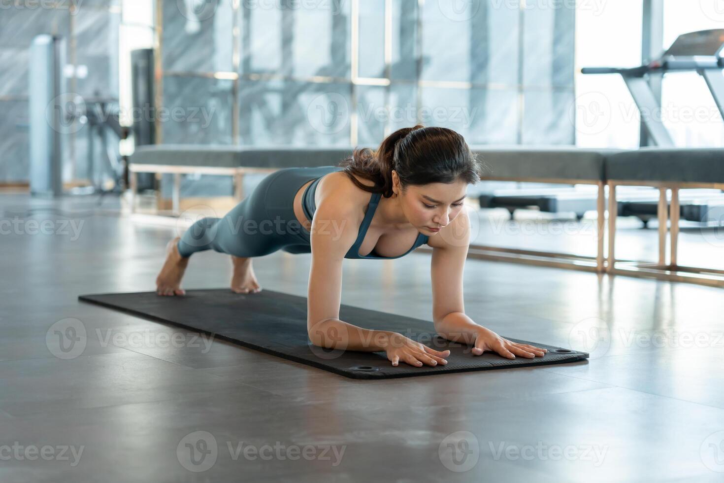 Slim woman practicing yoga on fitness at condo and city view. Asian woman doing exercises in morning. balance, meditation, relaxation, calm, good health, happy, relax, healthy lifestyle, diet, slim. photo