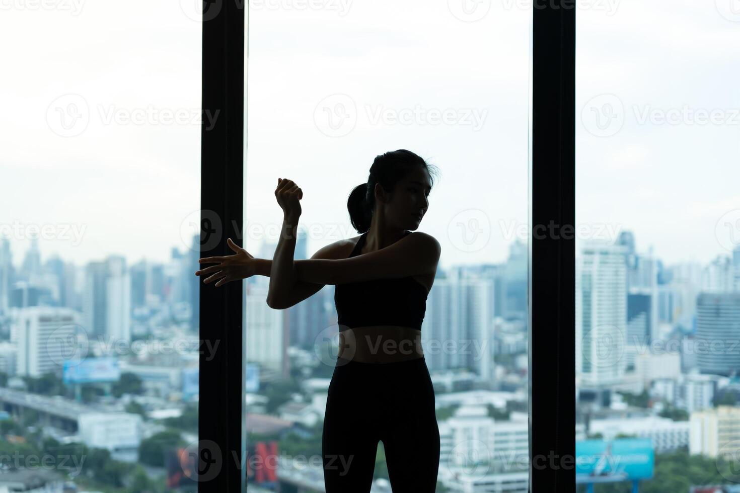 women practicing yoga on fitness at condo and city view. Asian woman doing exercises in morning. balance, meditation, relaxation, calm, good health, happy, relax, healthy lifestyle, diet, slim photo