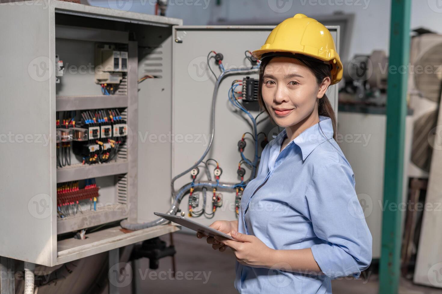 Mechanic or maintenance or electrical engineer checking main electrical control systems industrial plant. Utility fore man daily check power systems in process. Main Distribution Board. Switchboard. photo