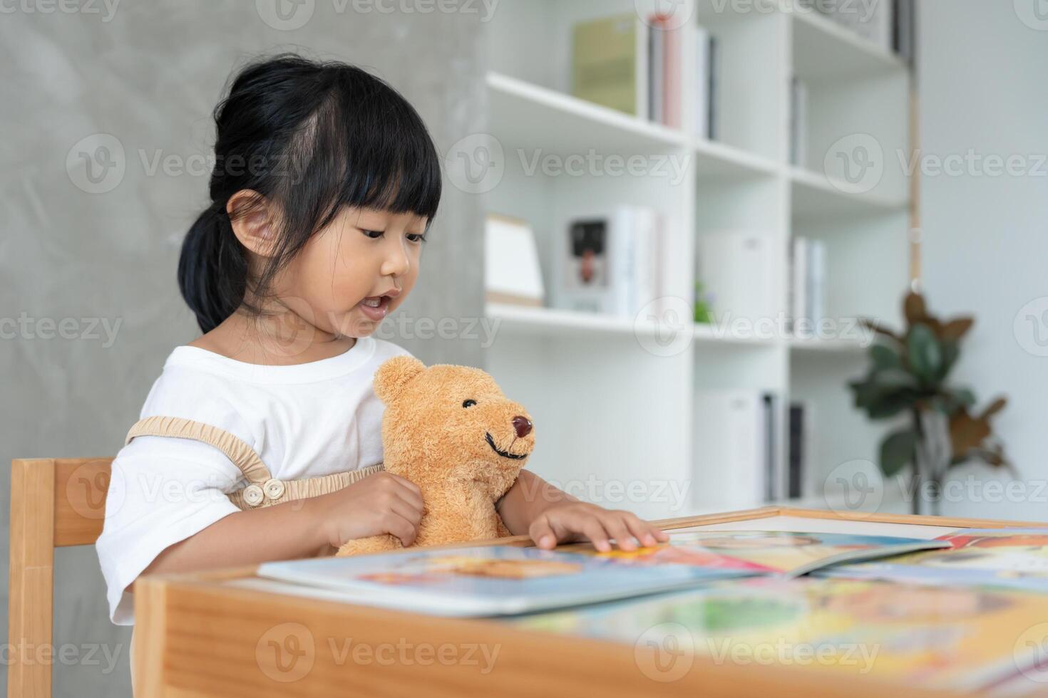 Happy Asian children relax read book at home. daughter and reading a story. learn development, childcare, laughing, education, storytelling, practice, imagine, reduce addiction mobile. photo